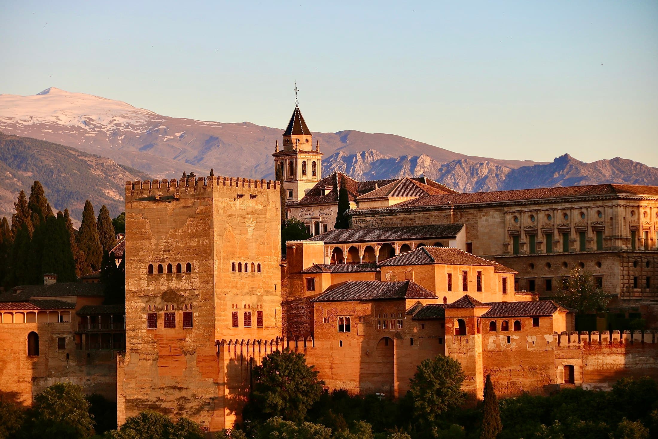 The Alhambra in Granada in the evening light, with the snowy Sierra Nevada behind