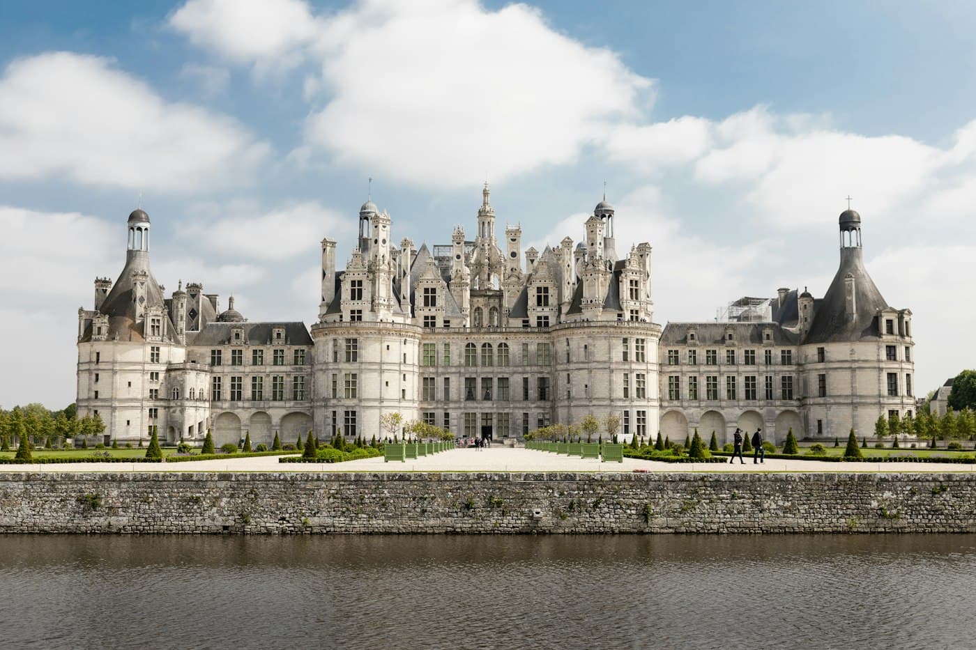 The Château de Chambord with its towers and chimneys under white clouds