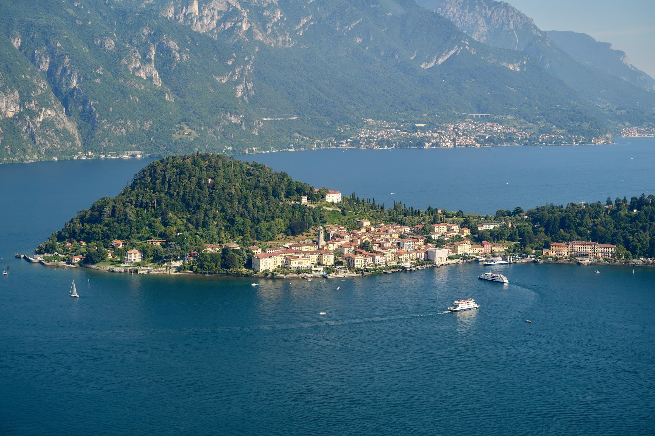 Bellagio from above: the wooded point and the village on the shore of Lake Como, ferries crossing the water