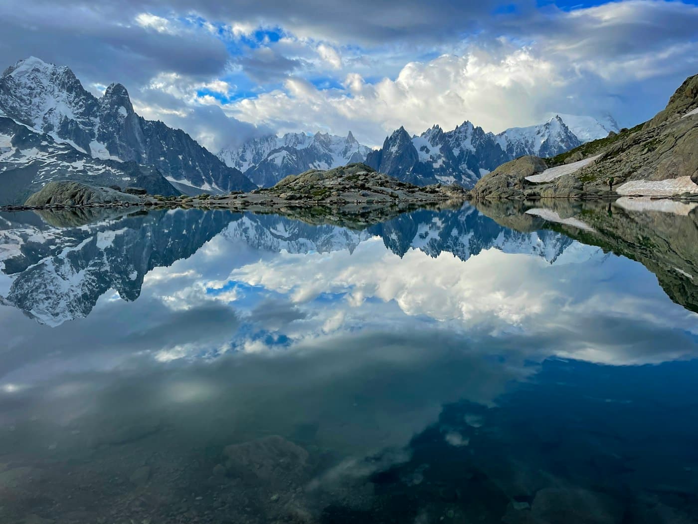 Lac Blanc above Chamonix, the peaks of the Mont Blanc massif and the clouds mirrored in its still water