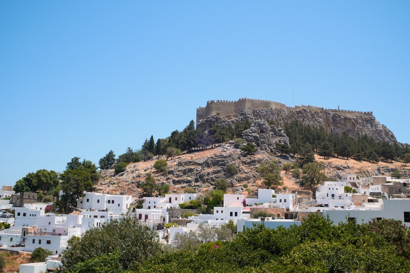 The Knights’ walls on the rock above Lindos, the village’s white houses below among pines and cypresses