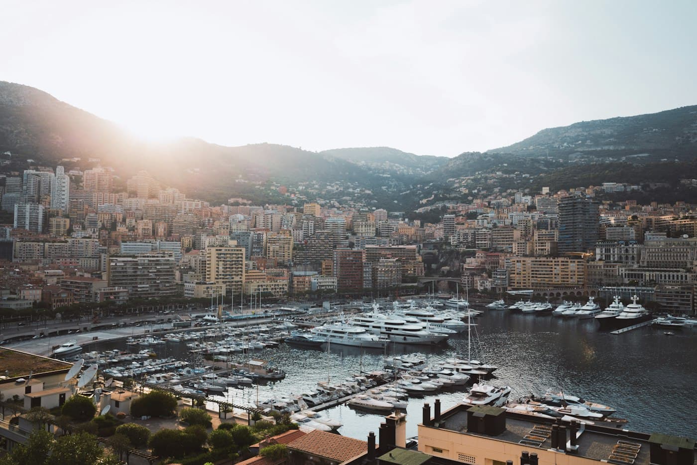 Port Hercule from above in the late light, its quays full of boats and yachts, with Monte-Carlo climbing the hills behind