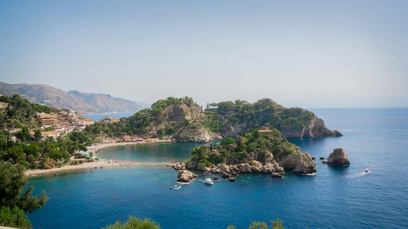 Isola Bella off Taormina, a small green island joined to the beach by a strip of sand in clear blue water