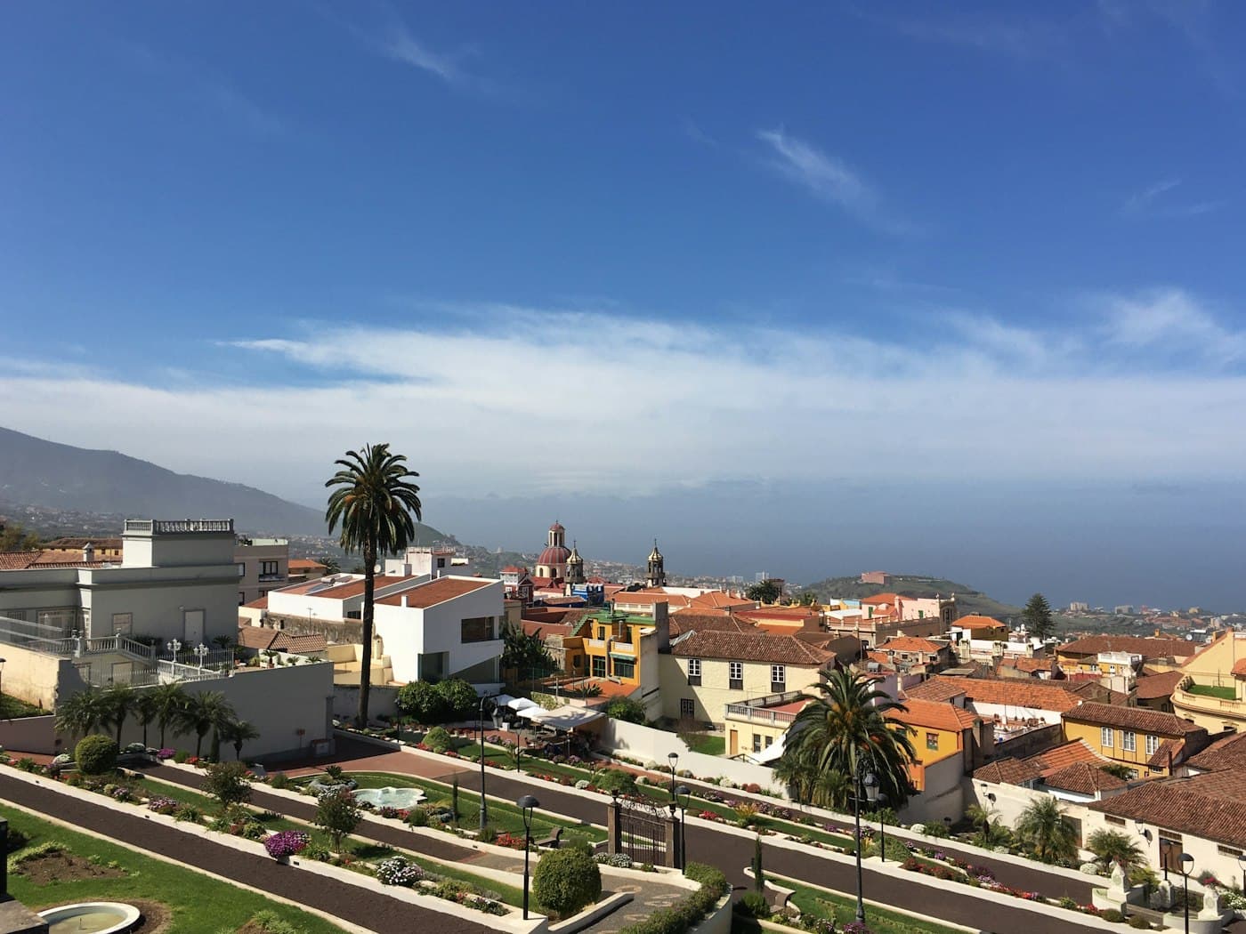 La Orotava from above: terraced gardens, tiled roofs and church domes, the Atlantic beyond