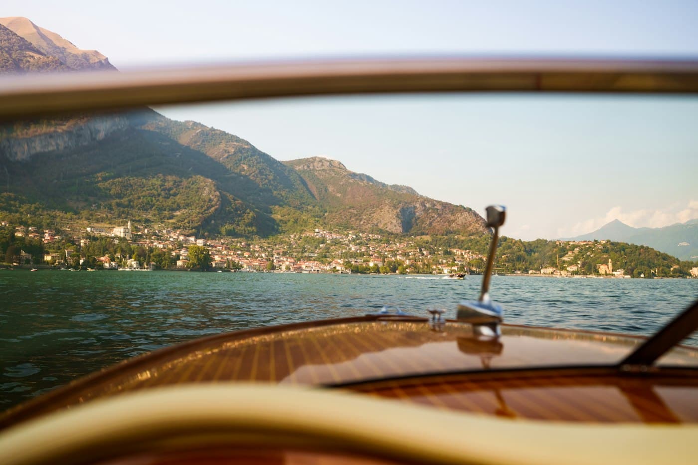Lake Como seen over the bow of a wooden boat