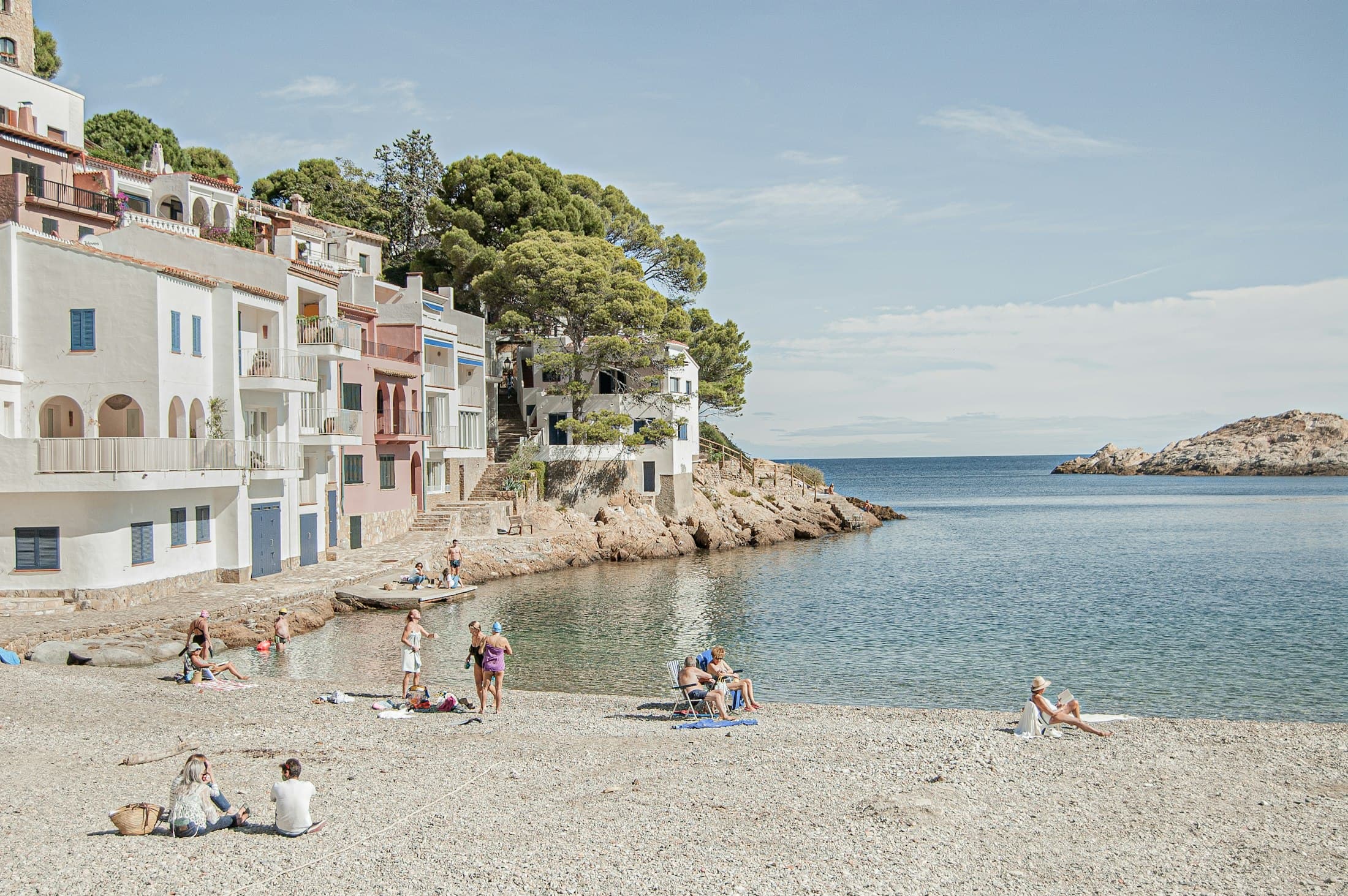White houses and a pebble beach on a cove of the Costa Brava