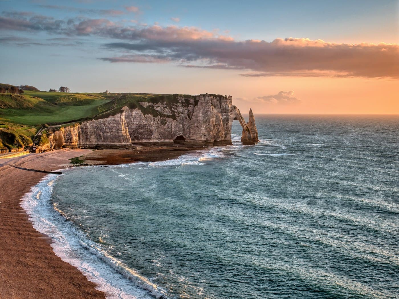 The white cliffs and sea arch of Étretat at sunset