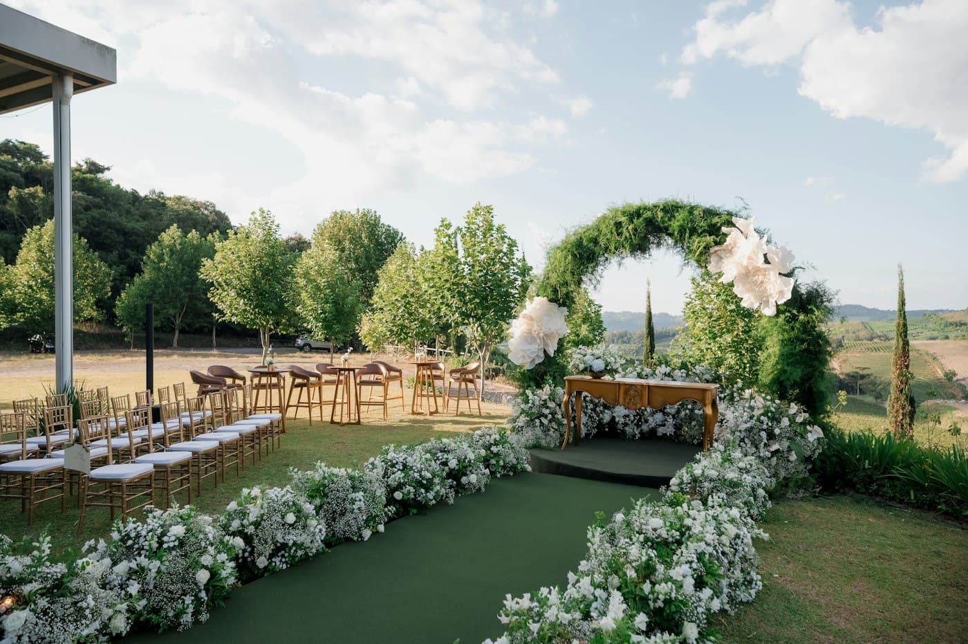 A garden ceremony arch with white flowers