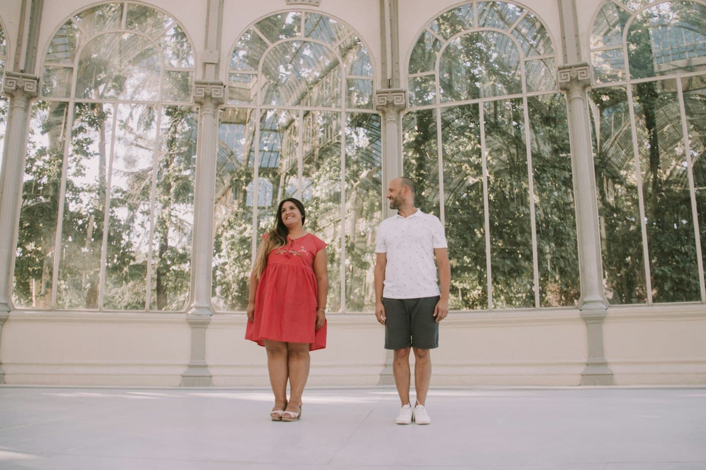A couple inside a glass palace in a Madrid park