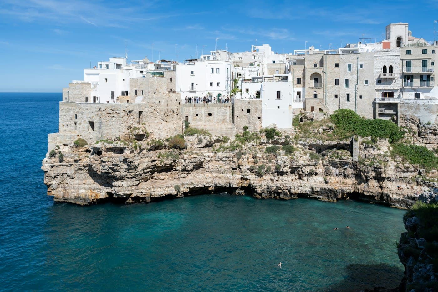 White houses on limestone cliffs over the sea at Polignano a Mare