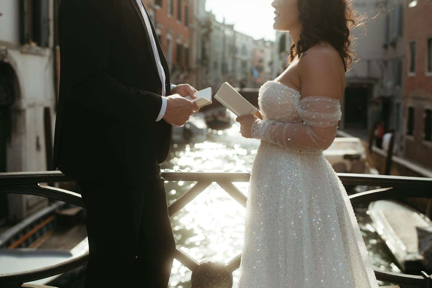 A couple reading their vows on a bridge over a Venetian canal