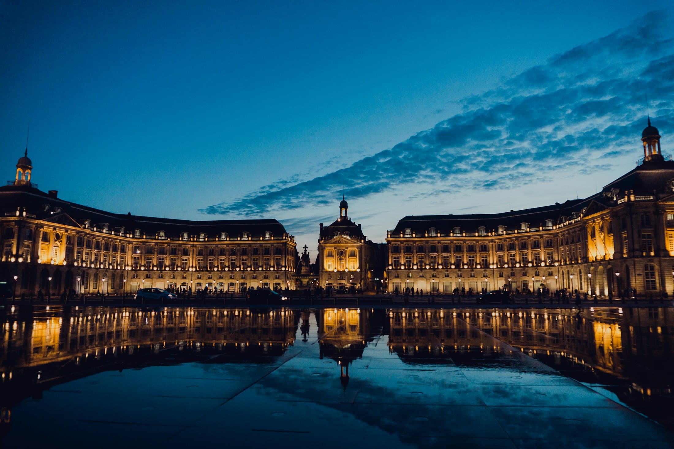 The Place de la Bourse lit at dusk and reflected in the water mirror, Bordeaux