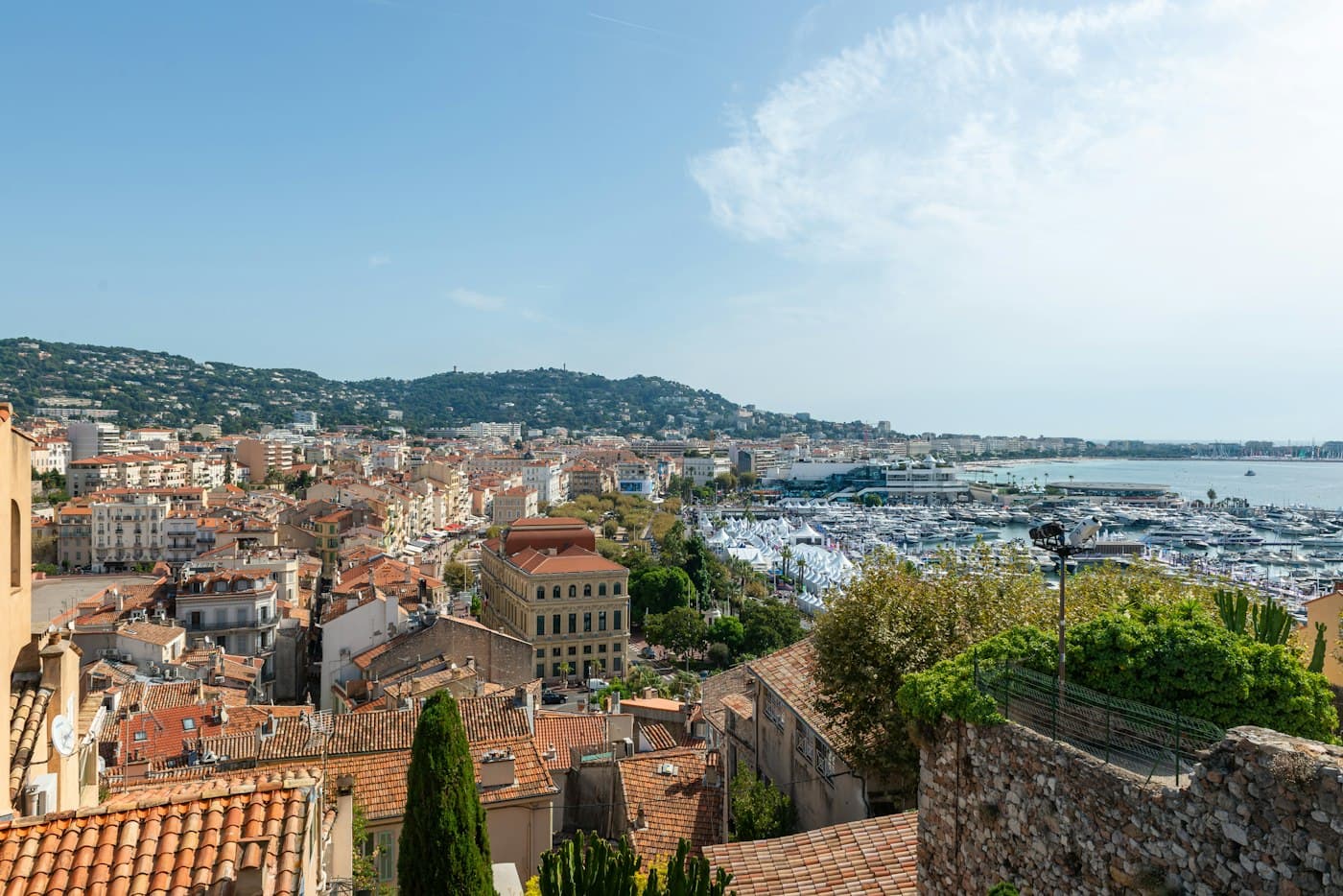 From the top of Le Suquet, the old town’s roofs above the Old Port full of boats, with the bay and the Californie hill beyond